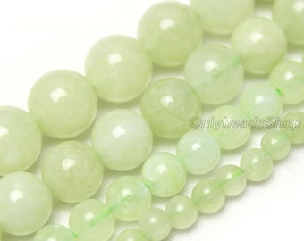 May include: A strand of light green jade beads in various sizes. The beads are round and smooth, with a subtle sheen. The beads are strung on a clear thread.