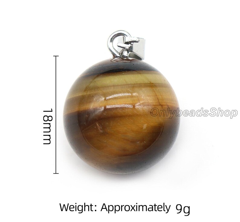 May include: A round, brown and gold tiger's eye gemstone pendant with a silver bail. The pendant measures 1.8 inches in diameter and weighs approximately 9 grams.
