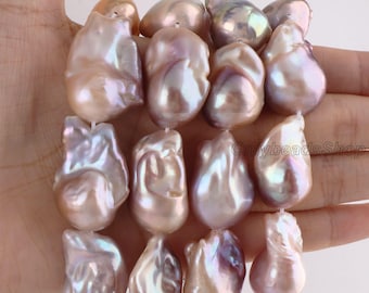 May include: A strand of irregular, baroque-shaped freshwater pearls with a lustrous, iridescent finish in shades of soft pink, lavender, and cream. The pearls are strung together, and the text OnlybeadsShop is visible on the right side.