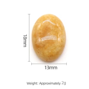 May include: A smooth, oval-shaped, yellow-orange gemstone measuring approximately 18mm by 13mm. The stone has a slightly translucent appearance with a subtle shimmer. It weighs approximately 2 grams.