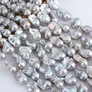 May include: A strand of baroque freshwater pearls in a silvery grey colour with iridescent highlights. The pearls are irregular in shape and size, with some being teardrop-shaped and others being more rounded.