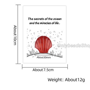 May include: A red seashell charm with a white outline, surrounded by white bubbles. The text "The secrets of the ocean and the miracles of life." is printed above the seashell. The charm is approximately 30mm in diameter and weighs about 12 grams.