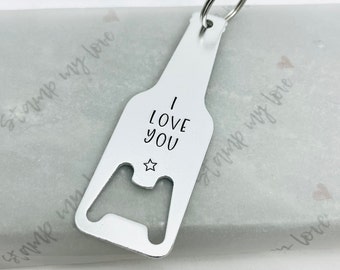 May include: Silver bottle opener keychain with a star and the text "I LOVE YOU".