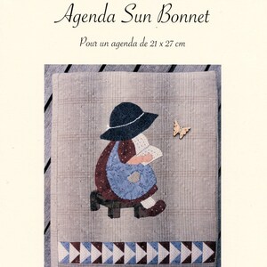 May include: A fabric art pattern titled "CROIX PATCH 74 Agenda Sun Bonnet." The cover features a patchwork design of a girl in a bonnet reading, with a butterfly accent. The pattern is for a 21 x 27 cm agenda.