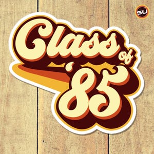 May include: A retro-style sticker with the text "Class of '83" in a yellow and brown color scheme. The text is in a bold, stylized font.