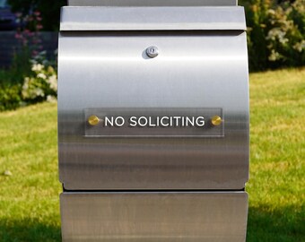 May include: A silver mailbox with a sign that reads "NO SOLICITING".