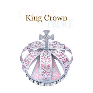 May include: A silver crown with pink glitter and a clear rhinestone on top. The crown has a cross on top and a band of rhinestones around the bottom.