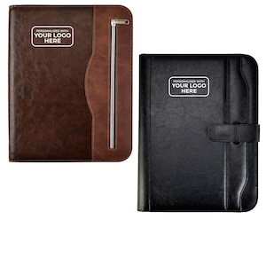 May include: Two leather business portfolios. One is brown with a zip, the other is black with a clasp. Both have a white rectangle with the text "PERSONALISED WITH YOUR LOGO HERE".