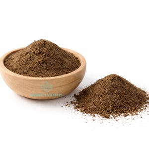 May include: A wooden bowl containing brown powder, with a separate pile of the same powder beside it. The bowl has a logo on it. The powder looks like a fine, ground substance.
