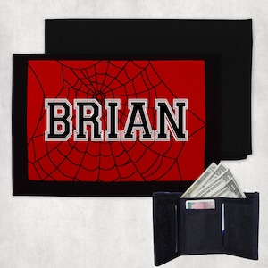 Billetera infantil personalizada. Billetera de nailon plegable de tres pliegues con fondo rojo y motivo de telaraña negra, personalizada con cualquier nombre