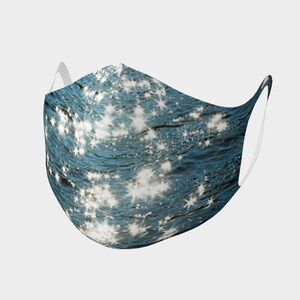 May include: A blue face mask with a white star pattern. The stars are scattered across the mask and appear to be reflecting light.