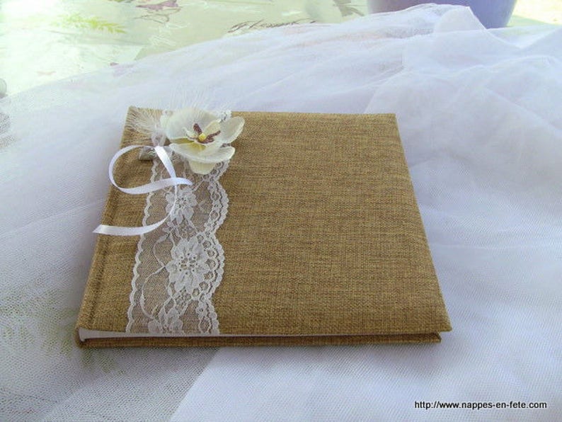 Guest book decorated with burlap lace and an orchid