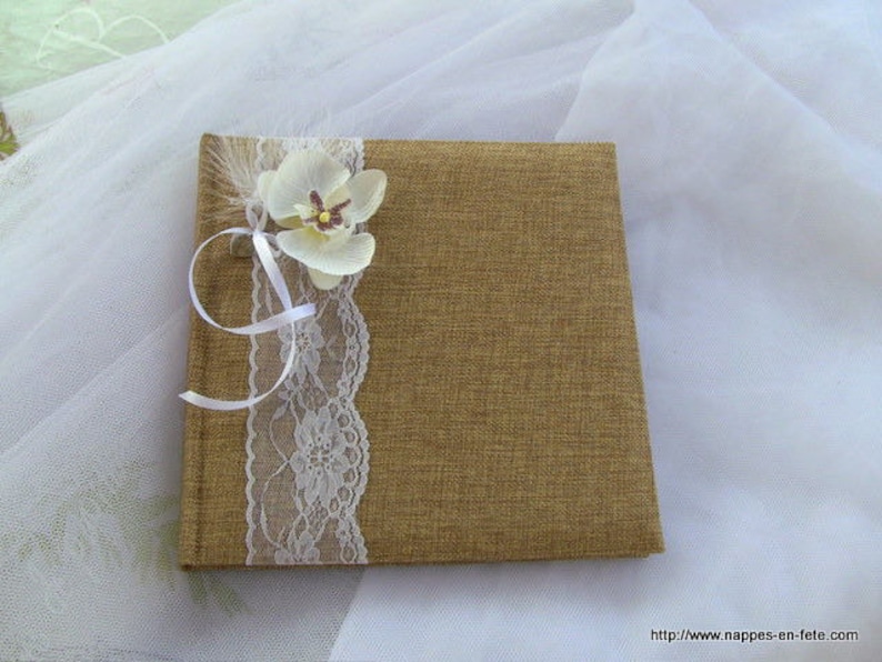 Guest book decorated with burlap lace and an orchid