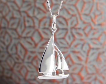 long necklace with steel chain and brass pendant in the shape of a sailboat handmade