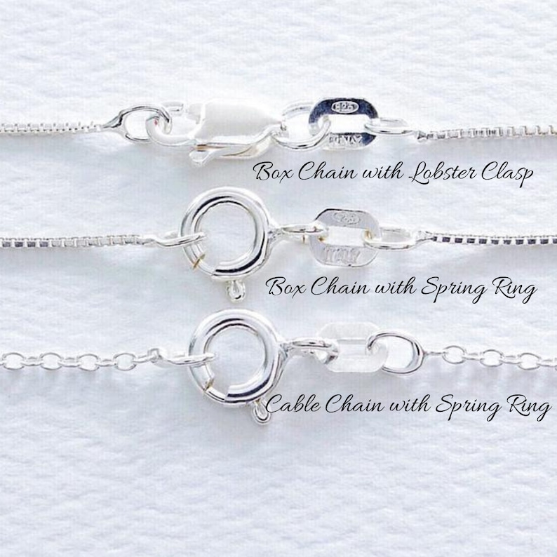 May include: Three silver chains with different clasps. The top chain has a lobster clasp, the middle chain has a spring ring clasp, and the bottom chain has a cable chain with a spring ring clasp.