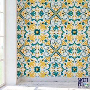 May include: A repeating pattern wallpaper with a white background and a blue and yellow geometric design. The pattern features a repeating motif of stylized flowers and leaves.