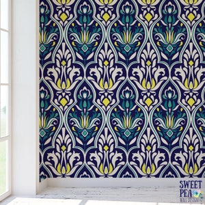 May include: Wallpaper with a repeating pattern of stylized floral motifs in navy blue, white, yellow, and teal. The design features a symmetrical arrangement of curved lines and shapes, creating a classic, elegant look. The text "SWEET PEA WALL DESIGN" is in the bottom right corner.
