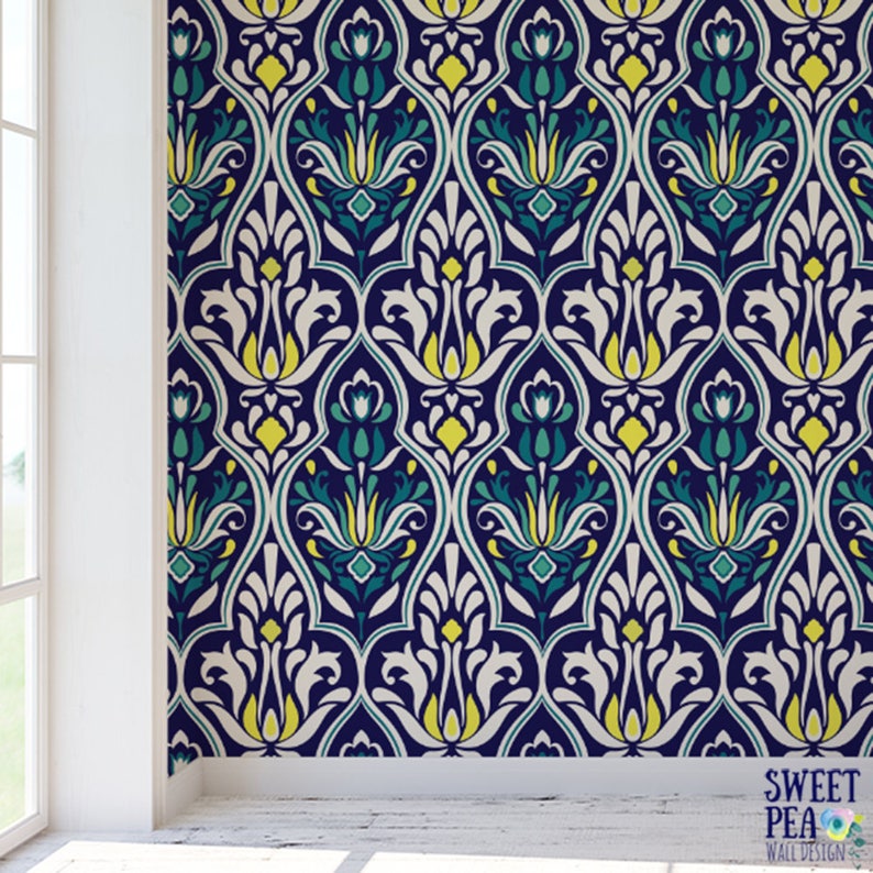 May include: Wallpaper with a repeating pattern of stylized floral motifs in navy blue, white, yellow, and teal. The design features a symmetrical arrangement of curved lines and shapes, creating a classic, elegant look. The text "SWEET PEA WALL DESIGN" is in the bottom right corner.
