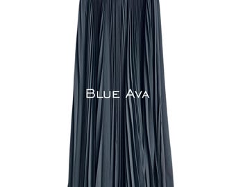 May include: A long, pleated skirt in a dark teal color. The skirt has a wide waistband and falls to the floor. The text "BLUE AVA" is printed in white across the skirt.