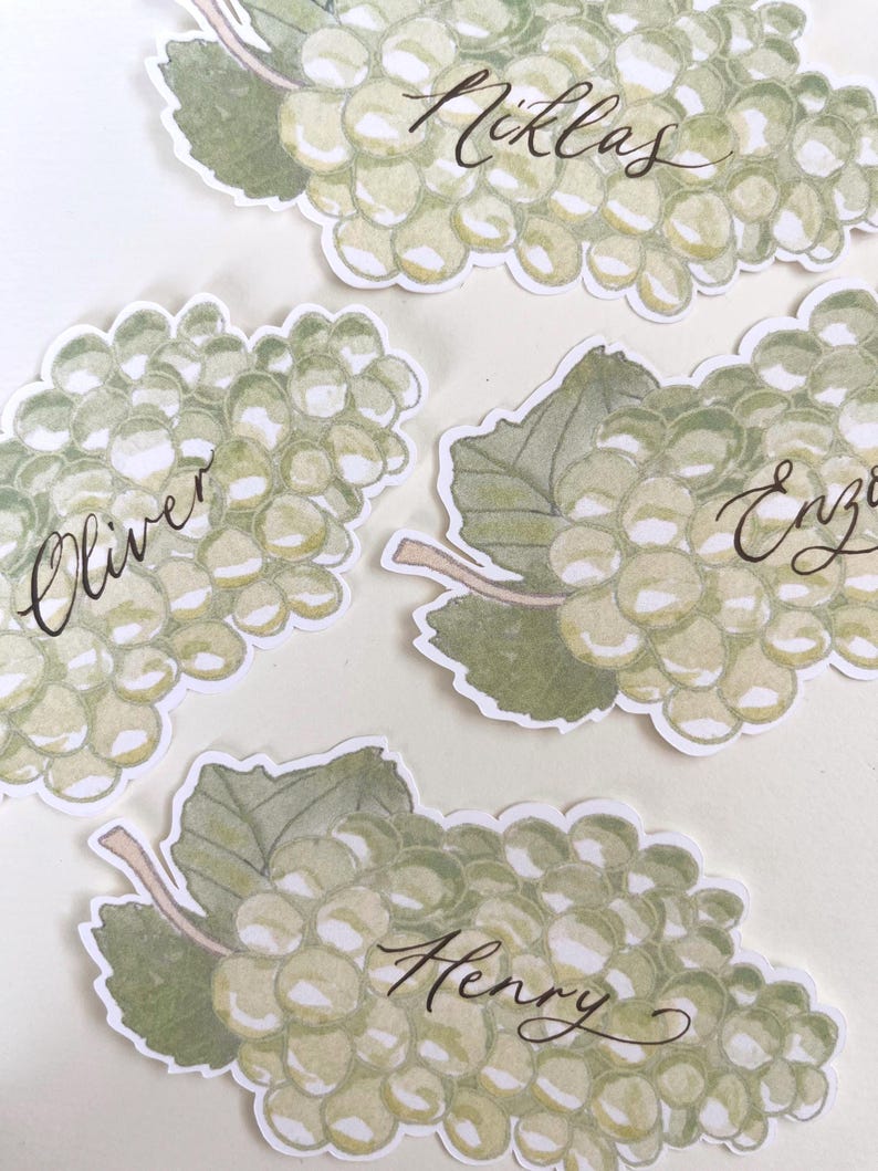 Hand painted and printed watercolour grape place cards with walnut ink personalised calligraphy guest names. Choose from a green bunch of grapes or a purple bunch of grapes. Or have a mix of both colours. Perfect for a Mediterranean wedding, winery event or a party on a vineyard. Classic grape place card are great for a long Italian or Greek lunch under the grapevines.