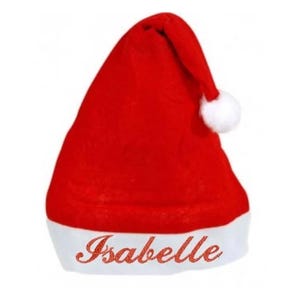 Peut inclure: Un bonnet de Père Noël rouge avec un bord blanc et un pompon blanc. Le nom "Isabelle" est brodé en cursive sur le bord blanc. Le chapeau est fait d'une matière douce et moelleuse.
