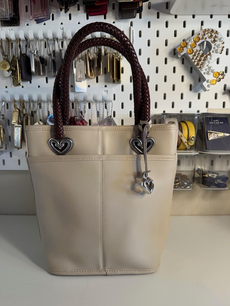 May include: A set of three ceramic mugs with a speckled, matte finish. The mugs are in shades of cream, light gray, and dark gray. Each mug has a simple, modern design and a comfortable handle.