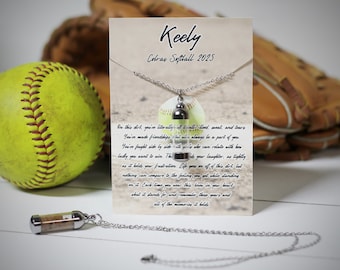 May include: A silver necklace with a softball-shaped pendant containing sand. The card reads "Keely Cobras Softball 2025" and includes a message about the memories and experiences of playing softball.