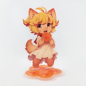 May include: A yellow and white anime character with a paw print in its hand. The character is standing on a clear acrylic base with a yellow and orange paw print design.