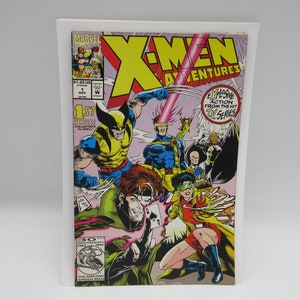 May include: A comic book cover featuring the X-Men, a group of superheroes. The cover is pink, blue, yellow, and green. The title is "X-Men Adventures". The cover features Wolverine, Cyclops, Rogue, Storm, Gambit, and Beast. The text on the cover reads "Explosive Action from the Hit Toy Series".