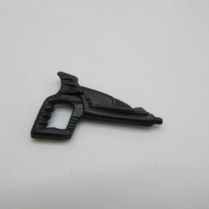 May include: A black plastic toy gun with a handle and a barrel. The gun has a futuristic design with details on the barrel.