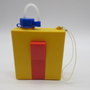 May include: A yellow plastic water bottle with a red and blue lid and a clear plastic strap. The bottle has a clear plastic straw attached to the lid.