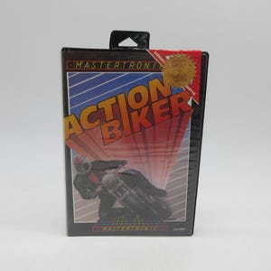 May include: A vintage video game cassette case for "Action Biker" by Mastertronic. The cover features a motorcycle racer in black and gray, with the game title in bold orange and red letters against a blue and white striped background.