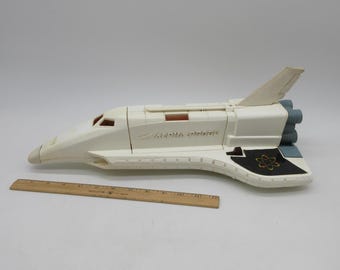 FLYPOP'S - Space Shuttle - Spazio - 022035 - Bianco - Metallo - Veicolo a retro-attro - Sonico e luminoso - Giocattolo per bambini - Batterie