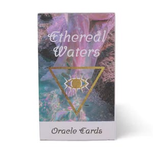 May include: A rectangular deck of Ethereal Waters oracle cards featuring a box with a pink and blue water-themed image, a gold triangle containing an eye symbol, and the text Ethereal Waters and Oracle Cards printed in a dark script font.