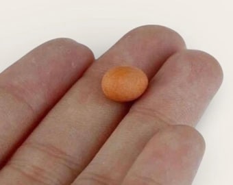 May include: A small, round, orange-colored bead with a smooth, matte texture. The object is spherical in shape and features a uniform, solid orange hue across its entire surface, appearing as a singular, compact, and lightweight decorative element.