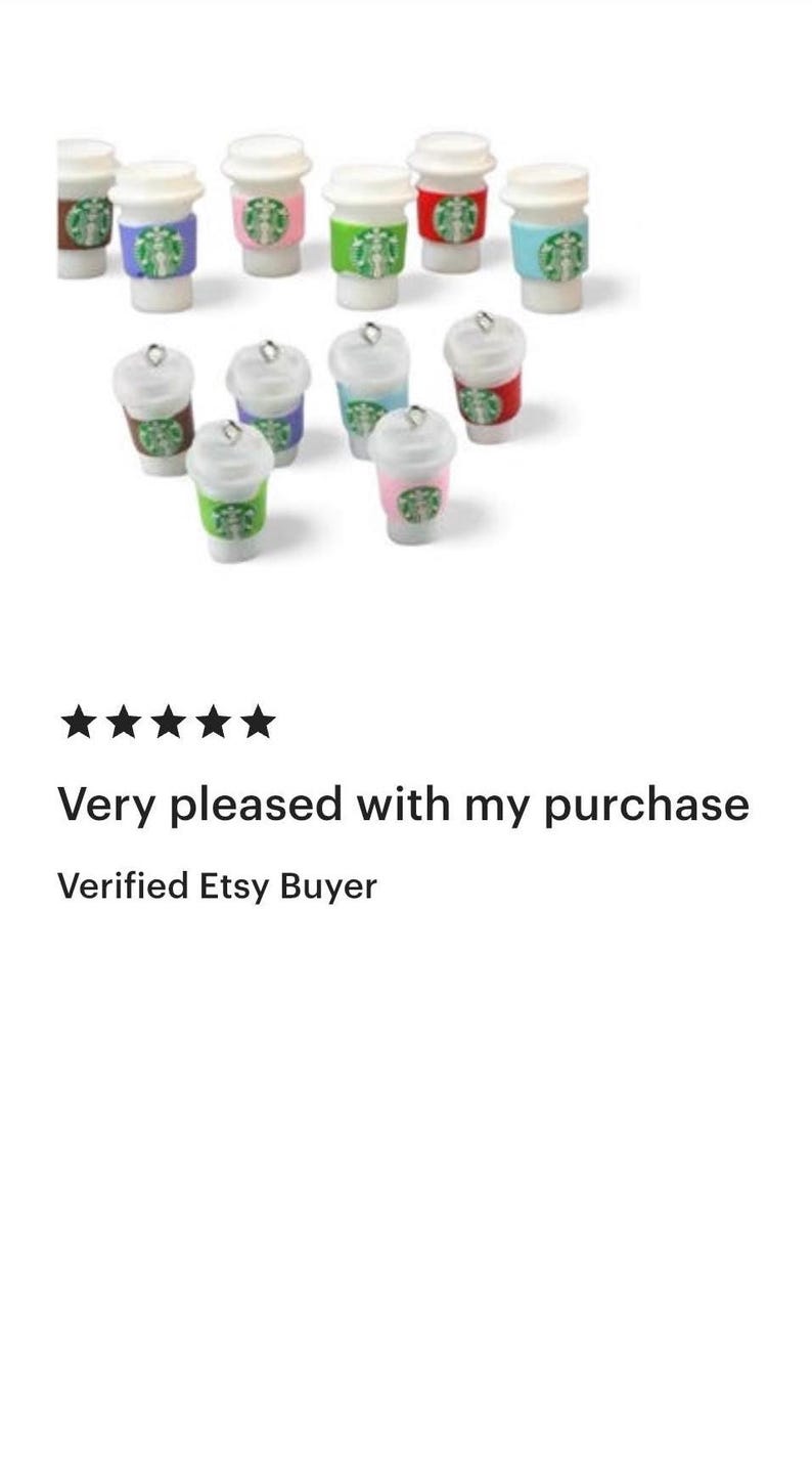 May include: Miniature coffee cup charms with white lids and colorful sleeves. The sleeves are in various colors, including green, pink, blue, and red. Each charm has a silver loop at the top.