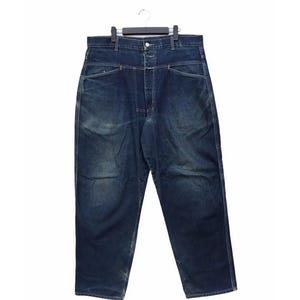 May include: Dark wash denim jeans with a high waist and straight leg. The jeans have a button closure and pockets. The jeans are hanging on a black hanger against a white background.