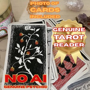 May include: A deck of tarot cards with a black and white design featuring a tree with fruit. The cards have the text "NOAI GENUINE PSYCHIC" and "GENUINE TAROT READER" on them. The image also includes crystals and a candle.