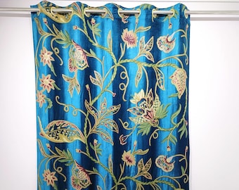 May include: A teal curtain with an embroidered floral design. The curtain features a repeating pattern of stylized flowers and leaves in shades of gold, green, and pink. The fabric has a subtle sheen.
