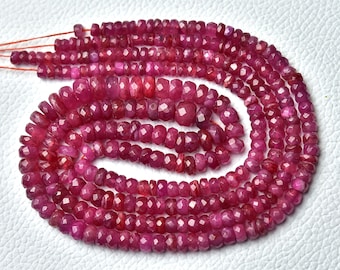 May include: A strand of ruby red faceted gemstone beads. The beads are small and have a slightly irregular shape. The beads are strung on a thin thread and are ready to be used for jewelry making.