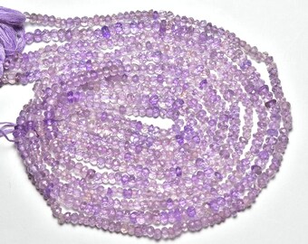 May include: A strand of light purple amethyst beads, each bead is faceted and has a slightly irregular shape. The beads are strung on a thin thread and are ready to be used for jewelry making.