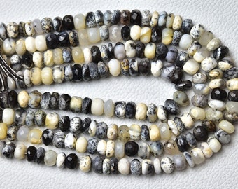 May include: A strand of white, black, and gray gemstone beads. The beads are faceted and have a natural, organic look.