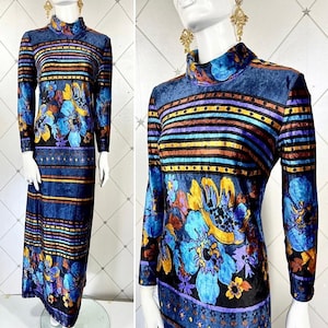 May include: A long-sleeved velvet dress with a blue, purple, and brown striped pattern and floral design. The dress has a high neck and long sleeves.