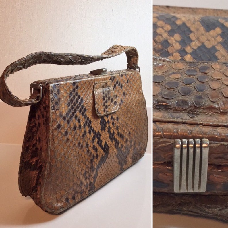 May include: A vintage brown and black snakeskin handbag with a silver clasp and a silver chain strap.