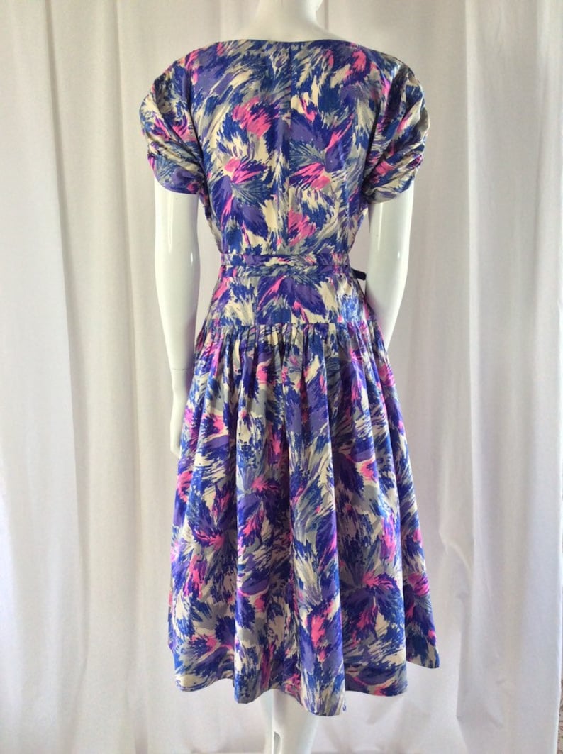 May include: A vintage dress with a floral print in shades of blue, pink, and white. The dress has a fitted bodice and a full skirt.