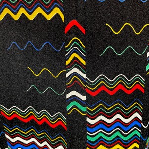 May include: Black fabric with a colorful wavy pattern. The pattern is made up of red, yellow, blue, green, and white wavy lines.