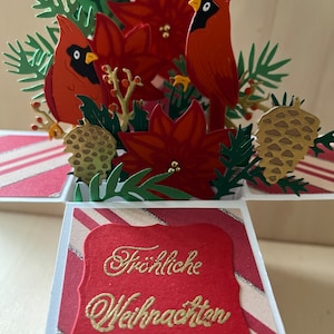 Traditional Christmas card with cardinals and poinsettias