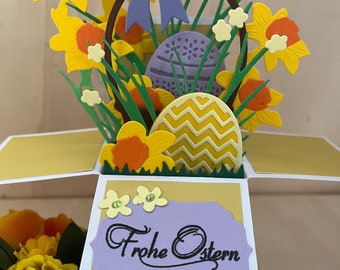 Easter card with colorful eggs, basket and daffodils