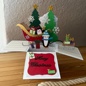Carte de Noël pop-up 3D avec traîneau de pingouins