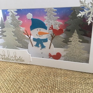 Große Slimline Shadow Box Weihnachtskarte Schneemann im verschneiten Wald